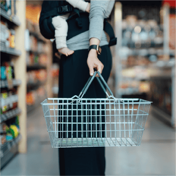A loyal customer buys groceries through her favorite brand's rewards program powered by embedded banking. 